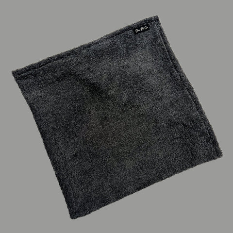 A folded dark grey pet towel with hand pockets, made from 100% cotton towelling, displayed on a white background.