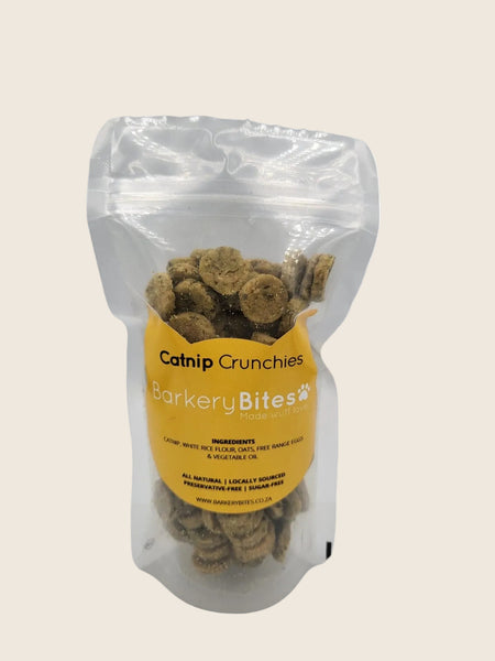 A clear plastic package containing catnip crunchies for cats, labeled 'Cat Treats Barkery Bites'.